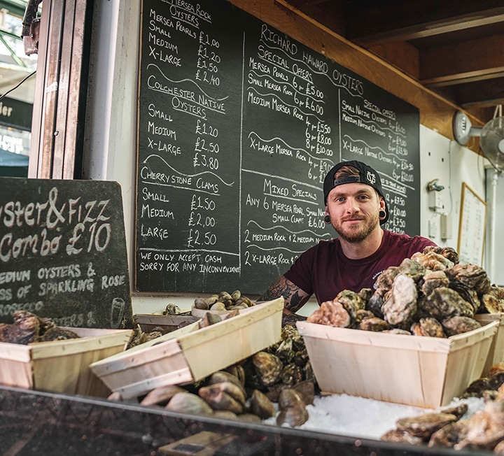 A man selling oysters at the Richard Haward's Oysters stand