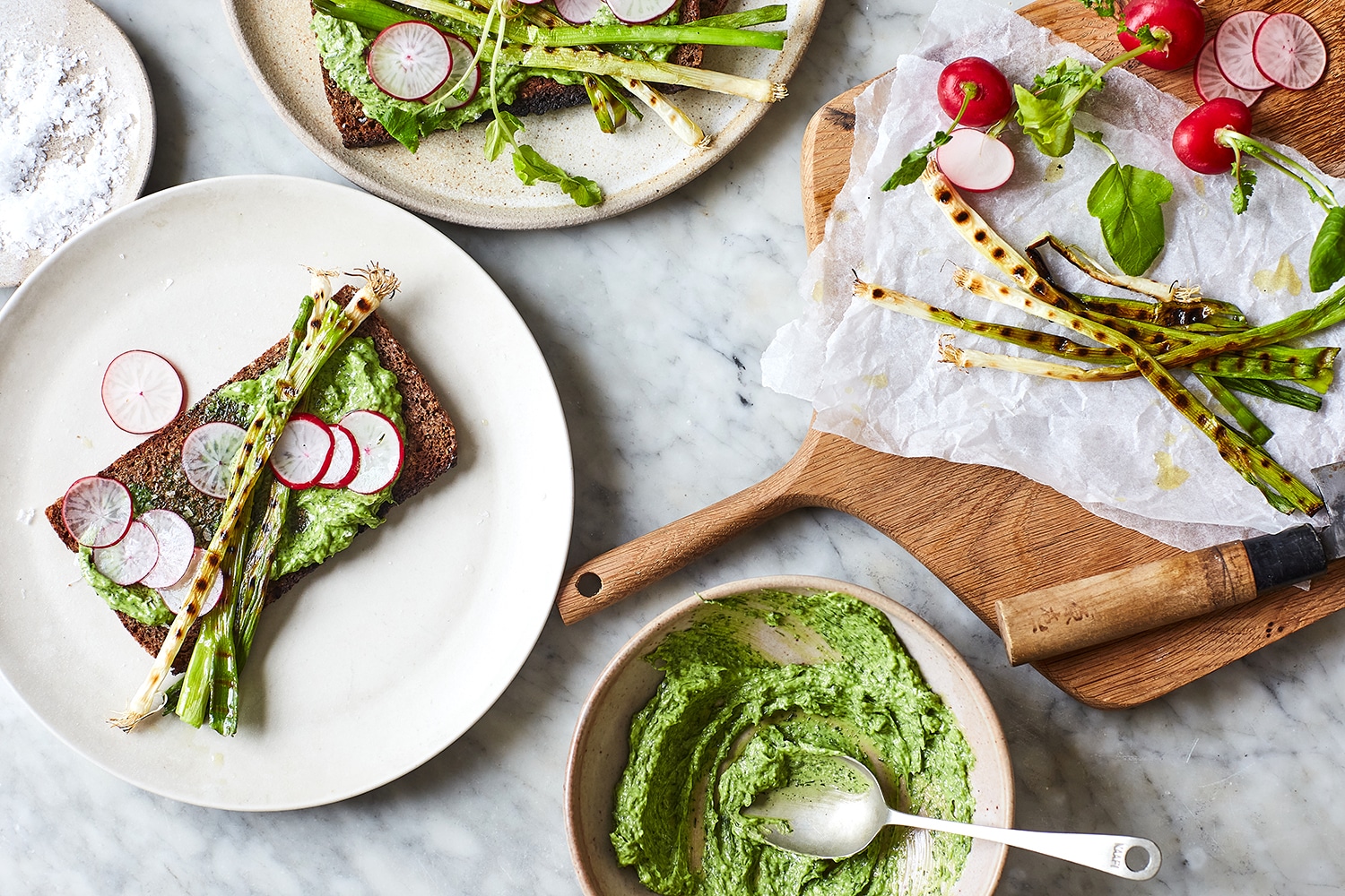Rye crostini with dill butter, radishes & spring onion
