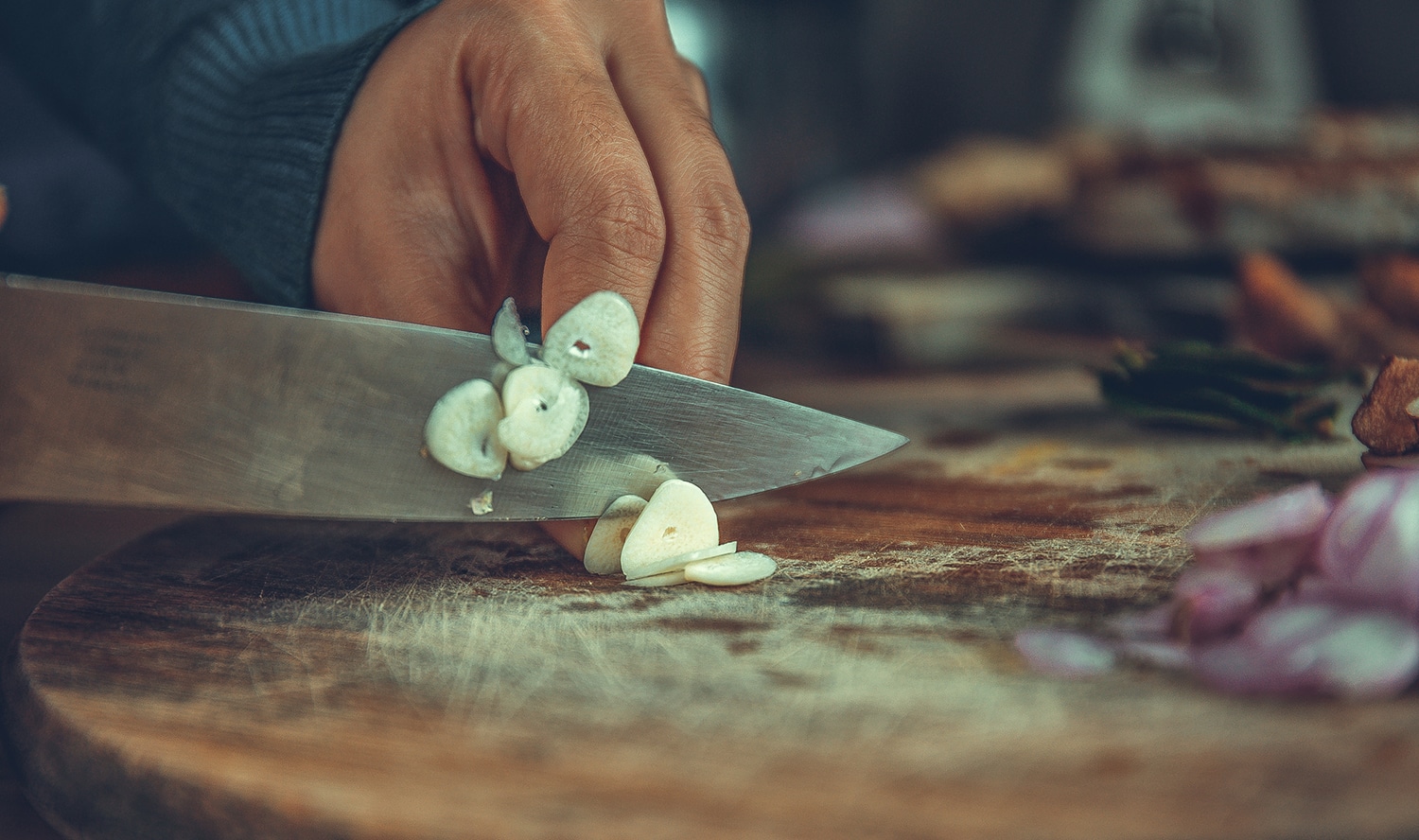 Woman chopping garlic
