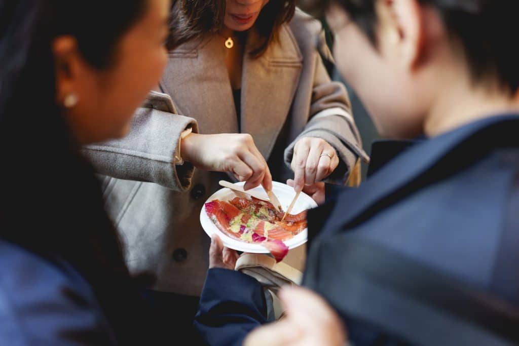 People sharing a small plate at the Evening of Seafood
