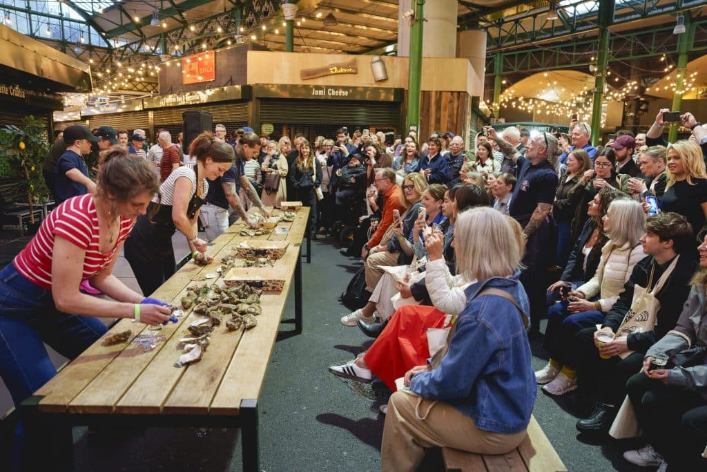 Guests watch the shuck-off at the Evening of Seafood