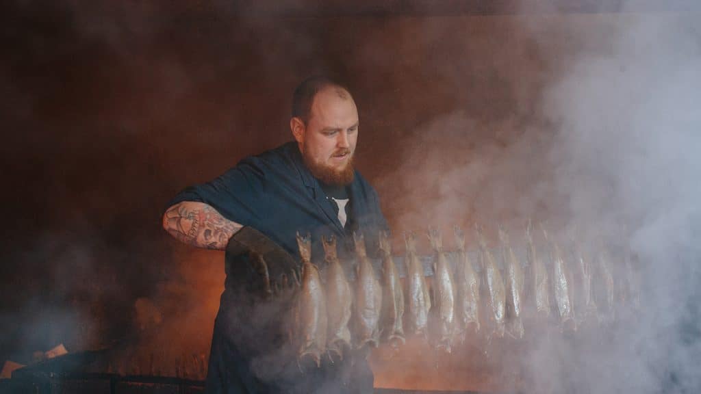 A man smoking Arbroath smokies