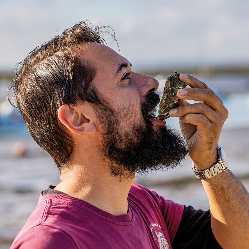 Tom Haward eats an oyster